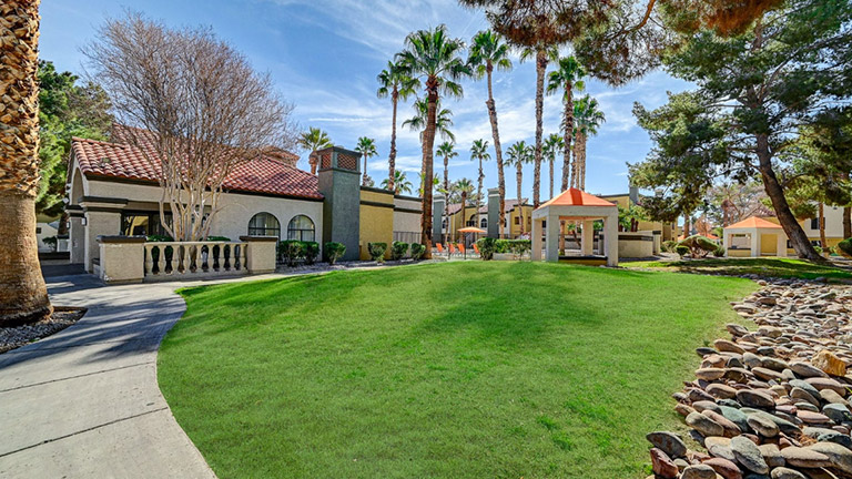 Residential house front view, lawn in front and trees